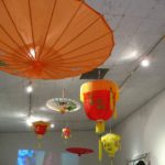 asian umbrellas and lanterns hanging from the ceiling